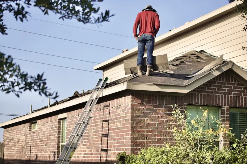 Professional roofer working on a residential roof in Central City